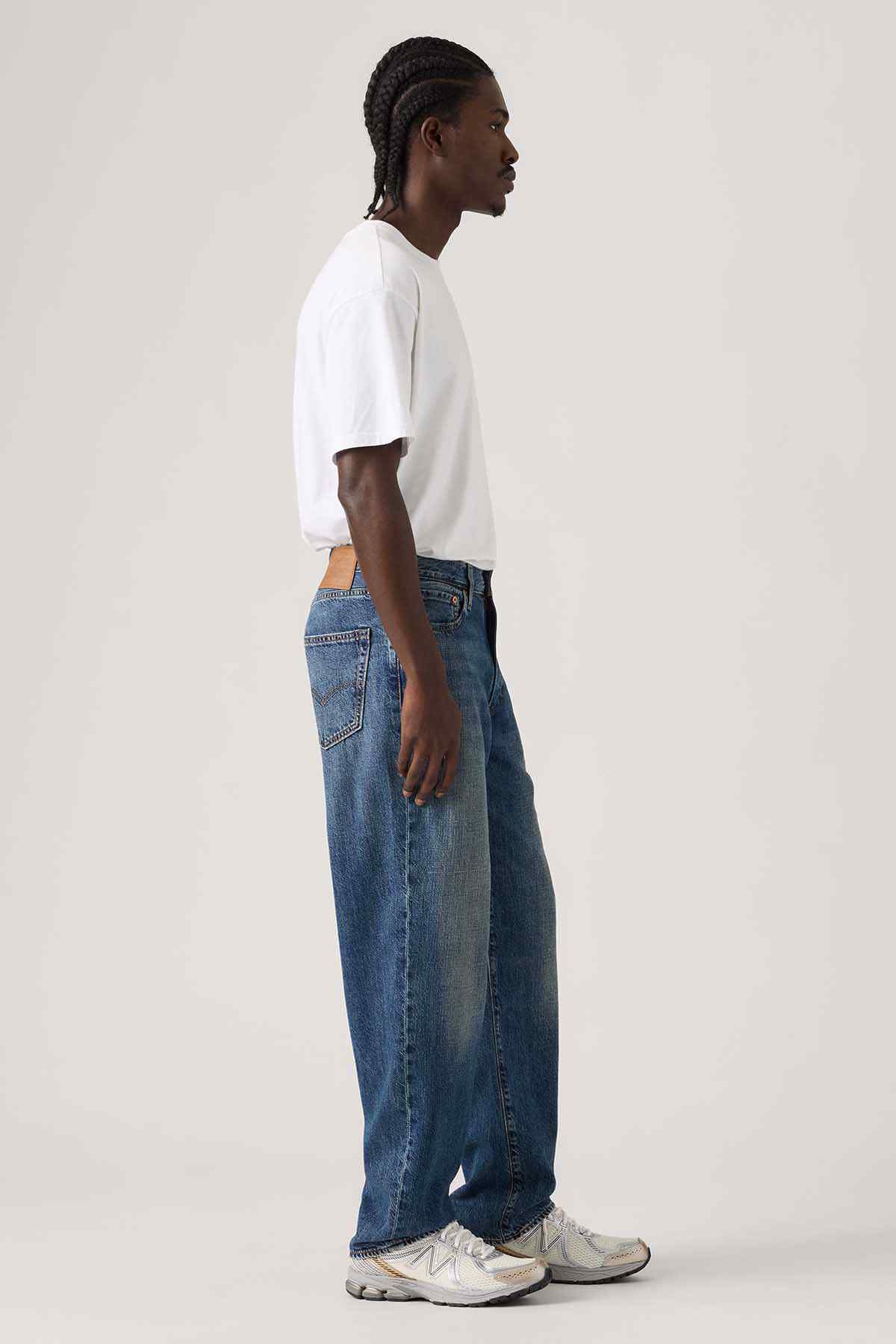 Dark wash denim jeans with relaxed straight fit and visible side seam