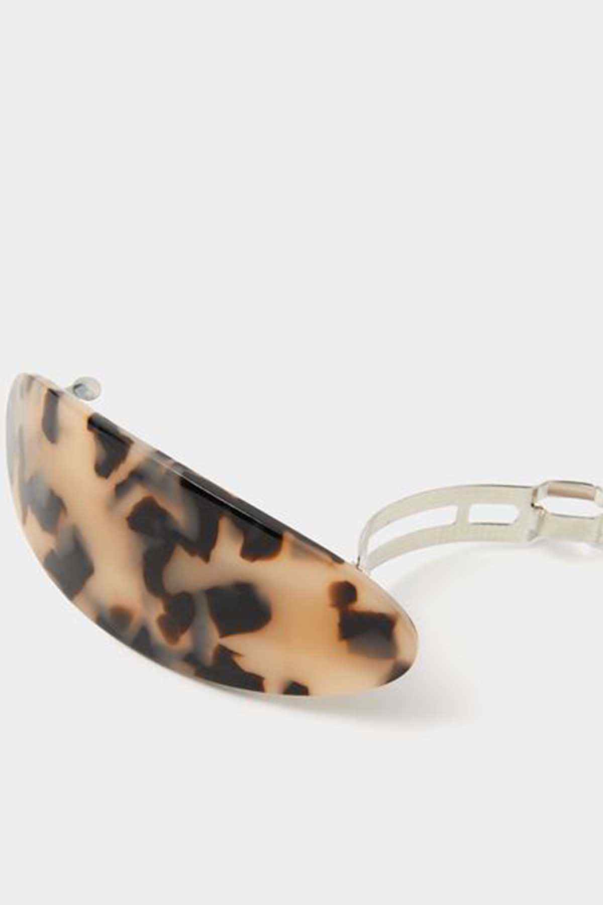 Tortoiseshell oval hair clip with white hinged clasp