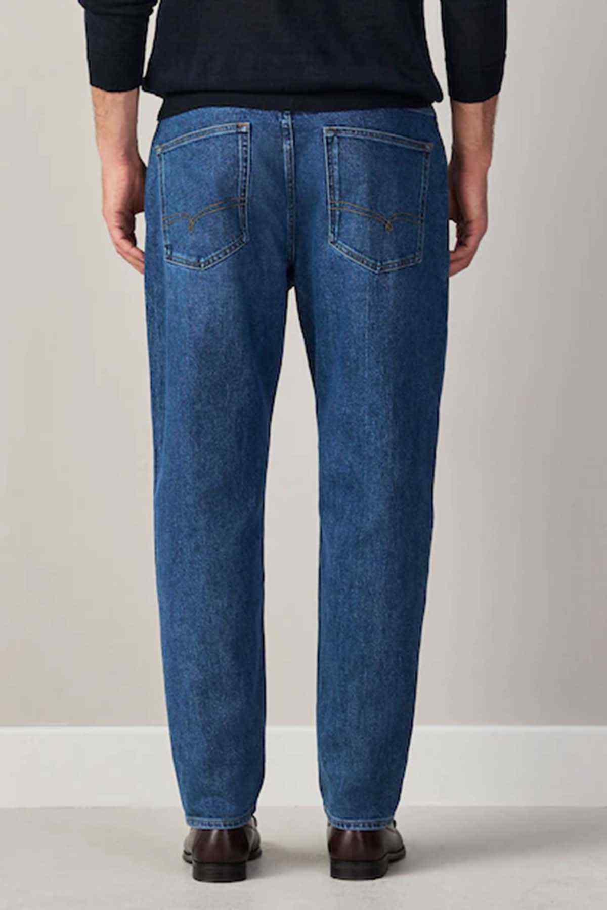 Men's mid-blue denim jeans with relaxed straight legs and back yoke seam