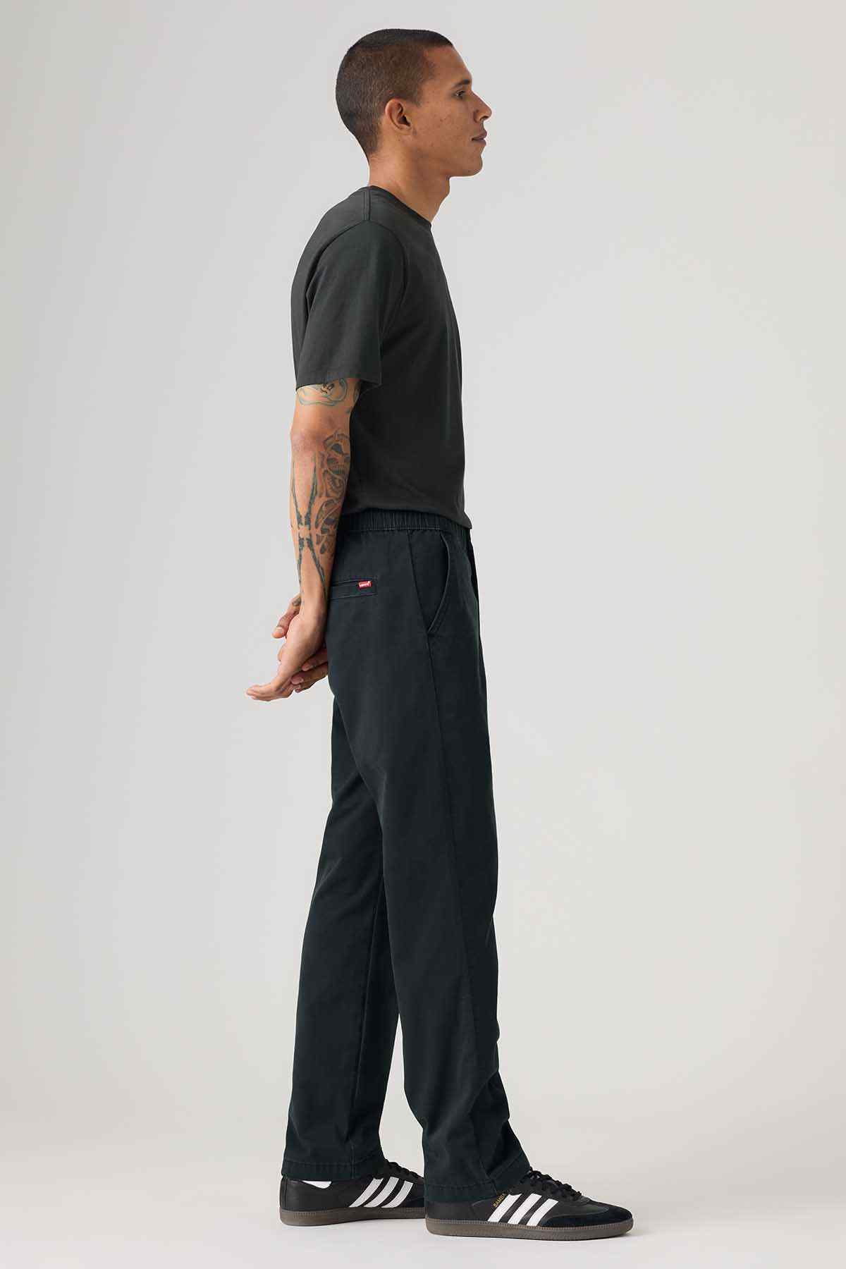 Men's black straight-leg pants with elastic waistband and small red logo tab