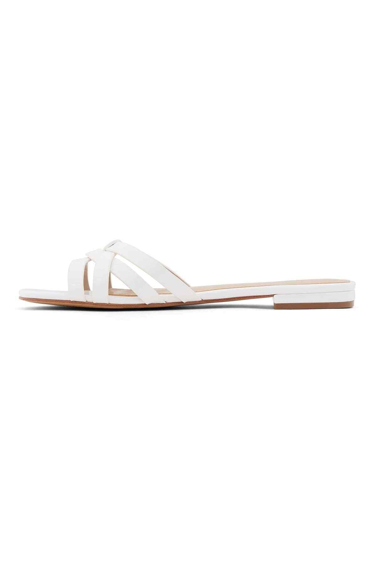 White open-toe slide sandals with diagonal strap detail and flat outsole