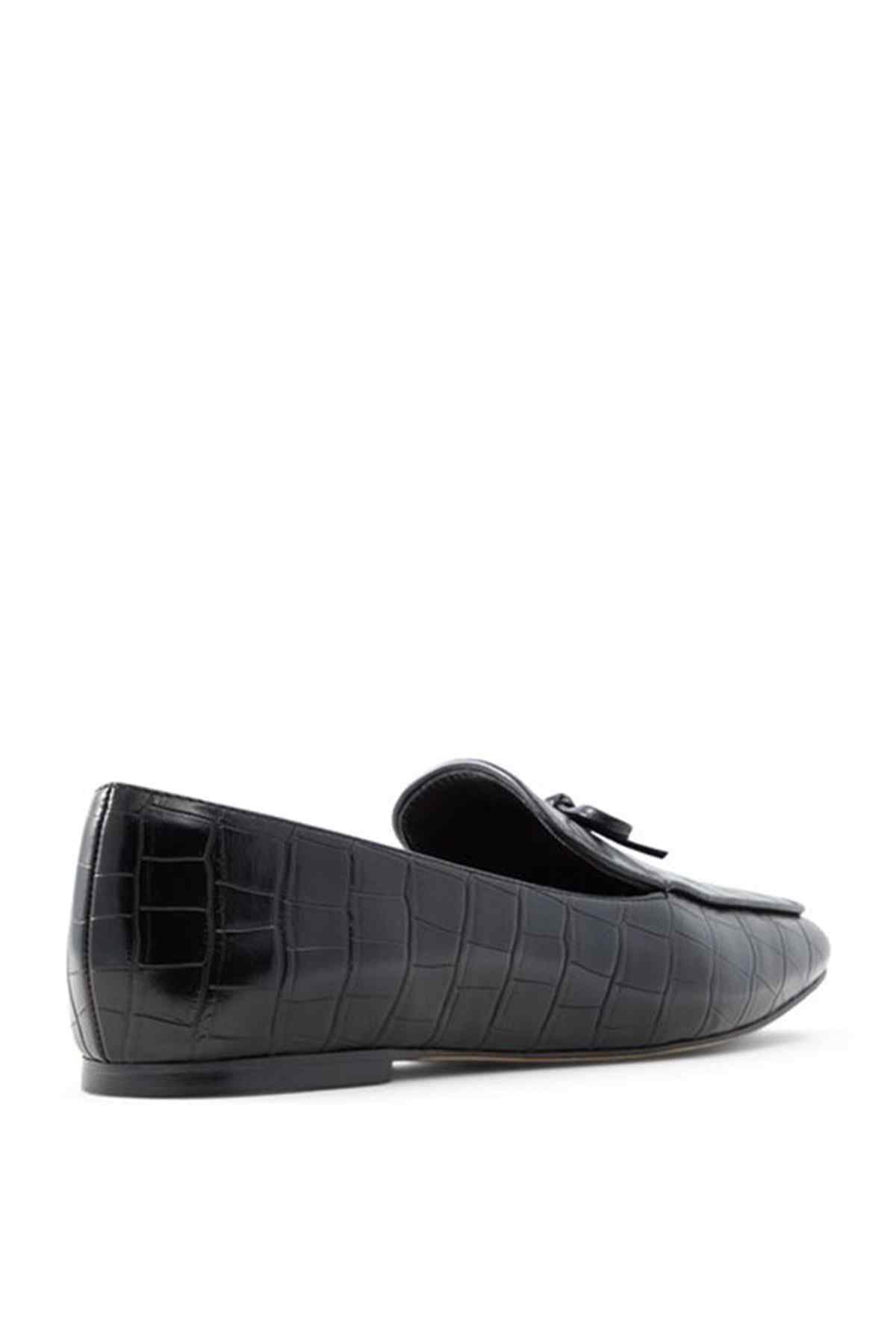 Black croc-embossed loafer with bow detail and rounded toe, side view