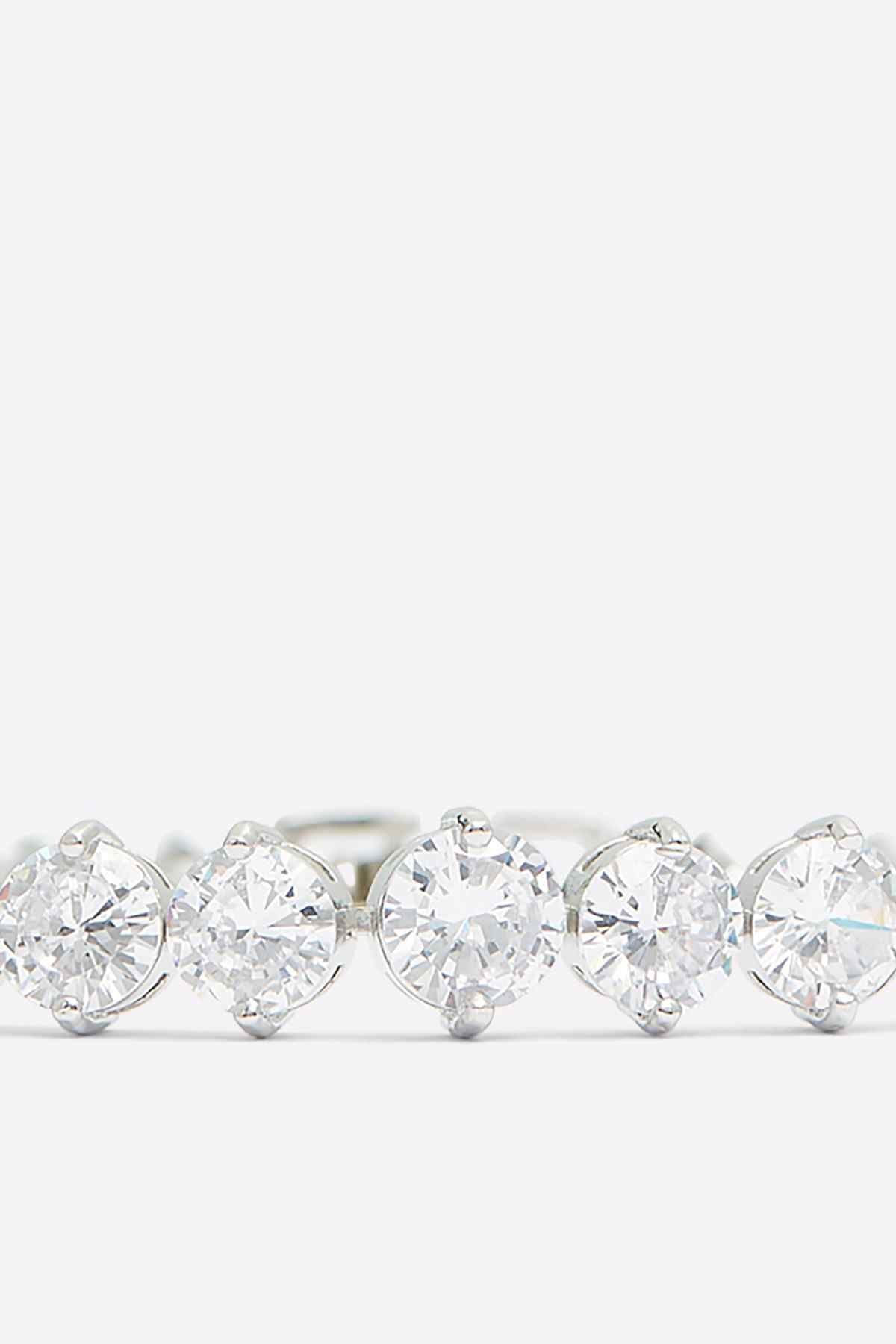 Silver tennis bracelet with a larger center clear stone and surrounding round stones