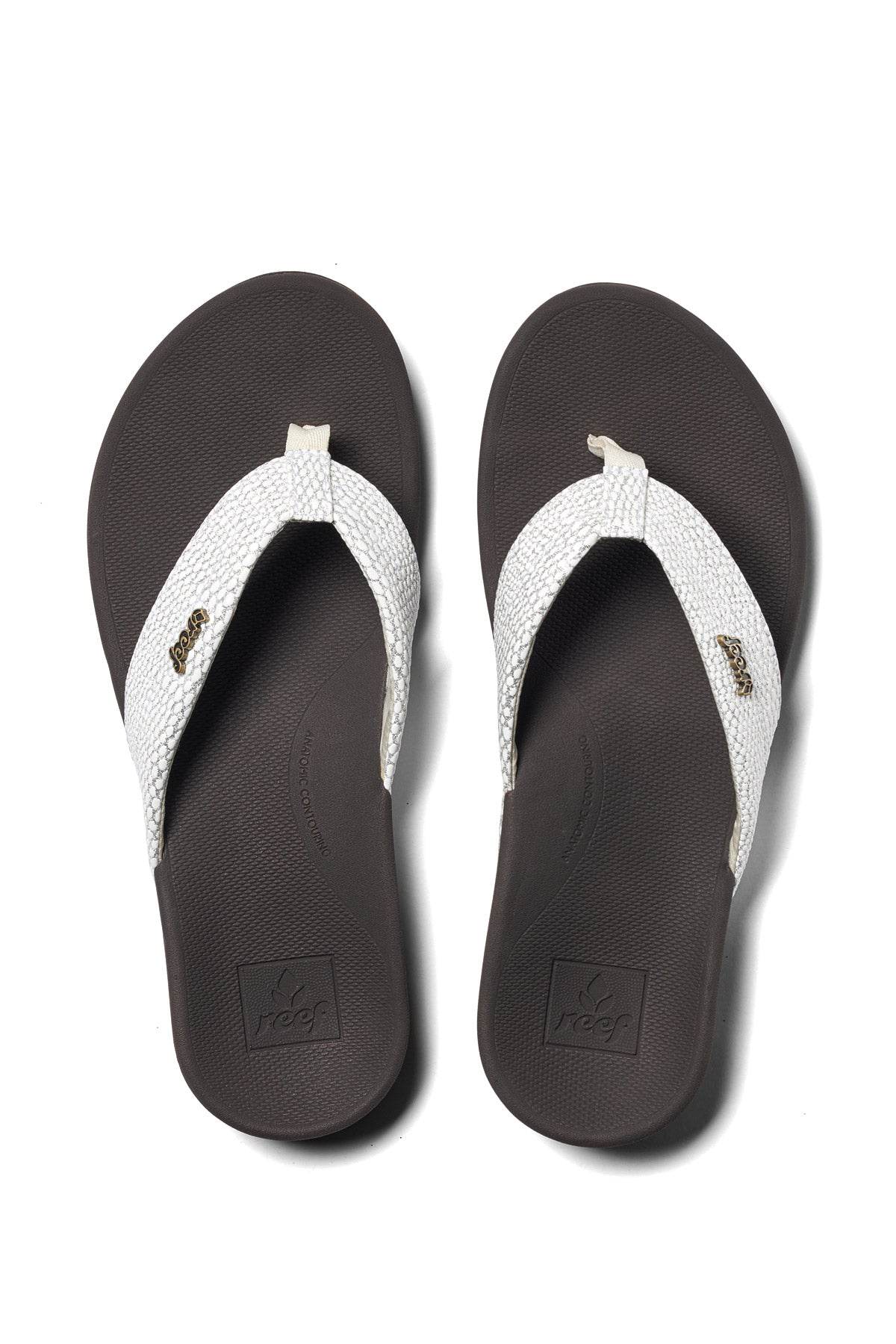 Brown flip-flops with two white woven straps and textured rubber footbed