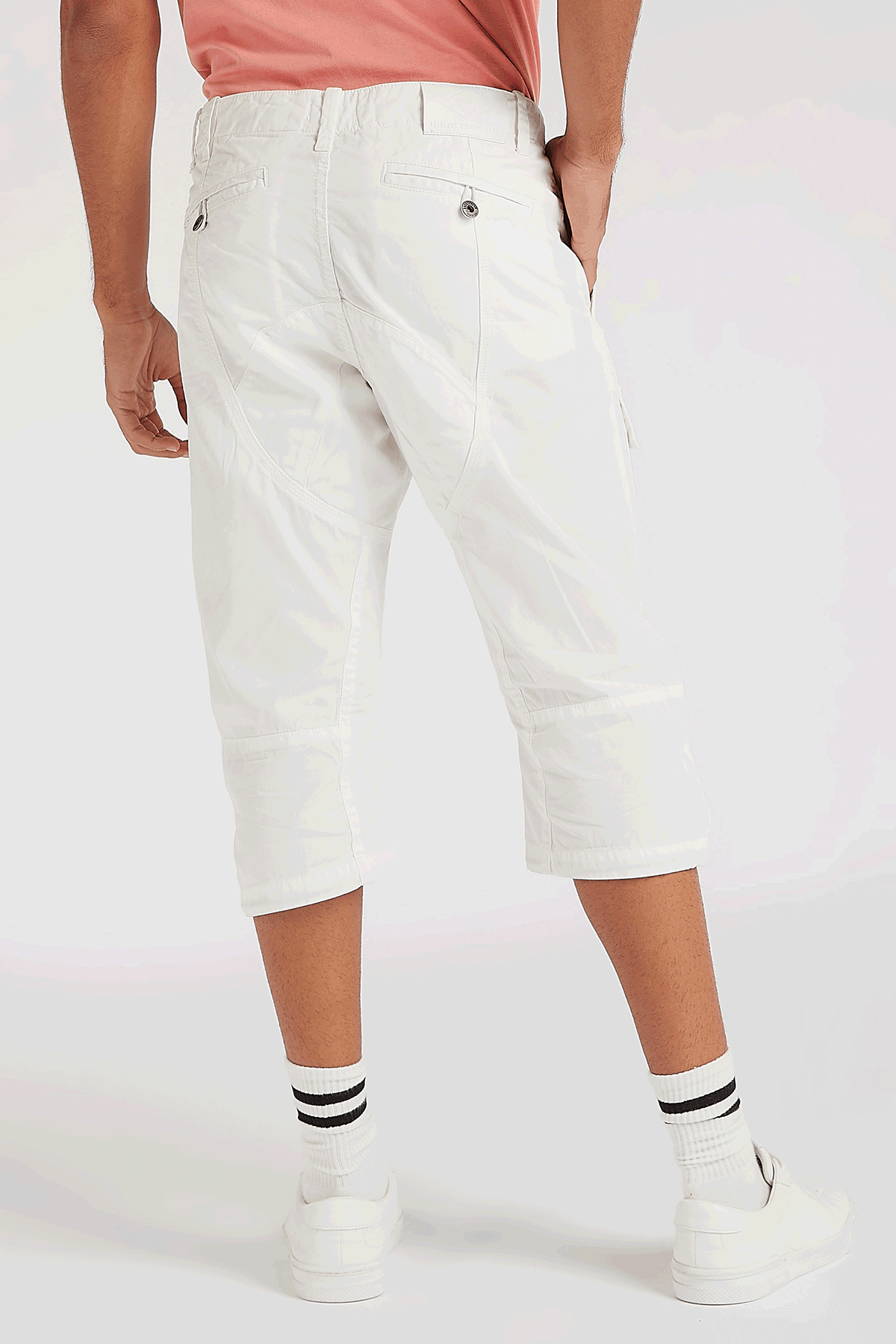 White knee-length cargo shorts with back patch pockets and straight hem
