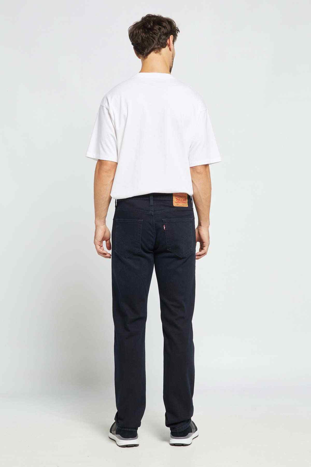 Men's black denim jeans, back view with straight legs