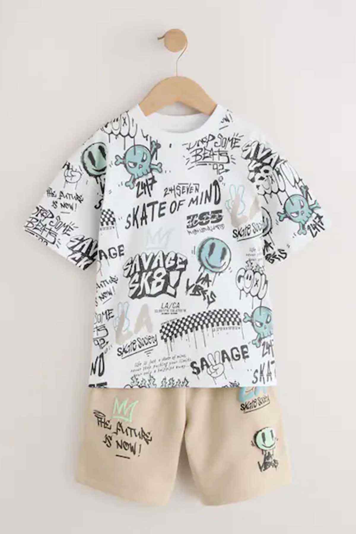 Kids tee and shorts set, front view flat lay: white graphic T-shirt and stone shorts.