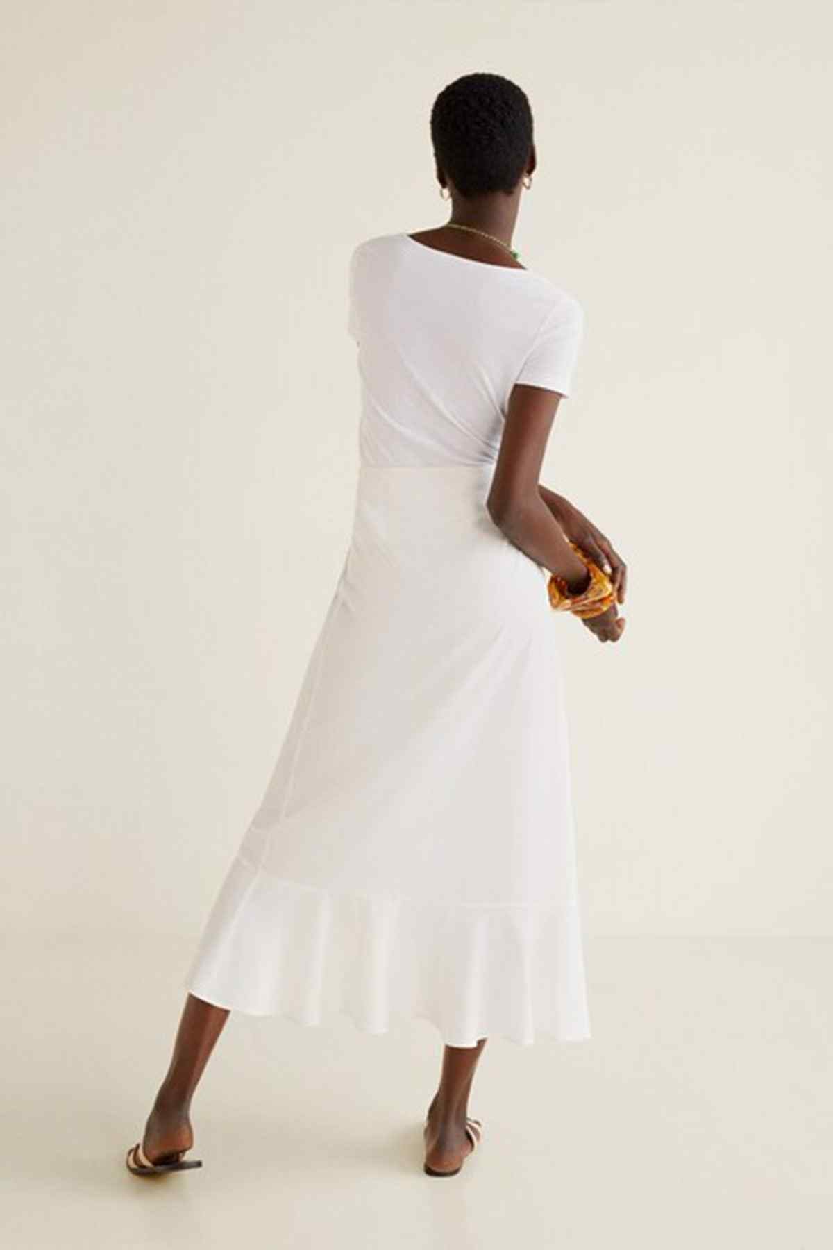 Off-white midi dress back view with short sleeves and tiered A-line skirt hem
