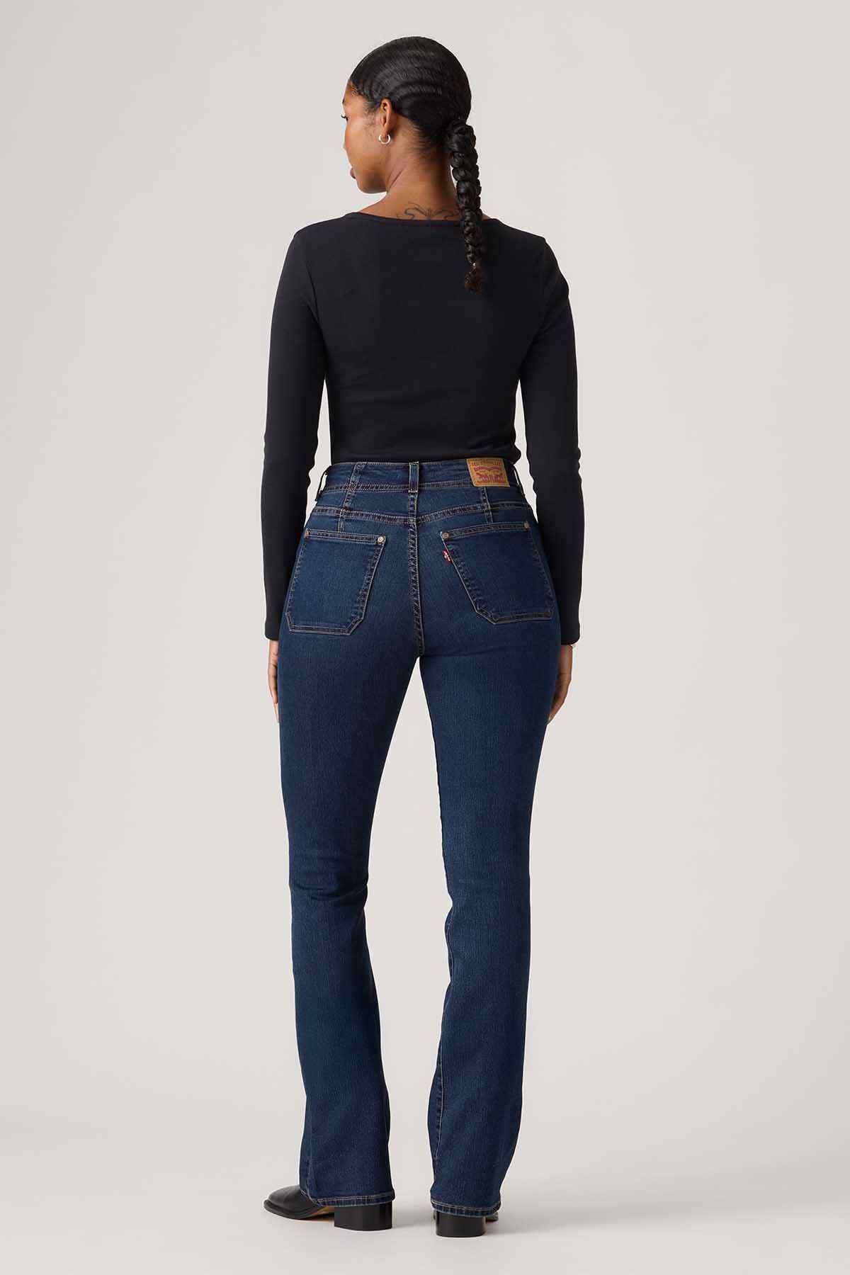Blue denim jeans back view with yoke detail and straight legs
