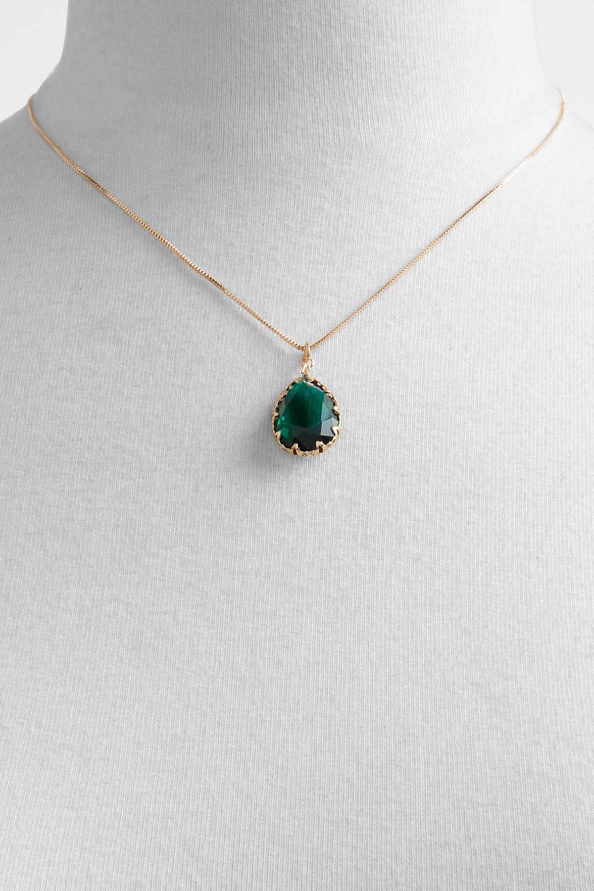Gold-tone necklace with green oval gemstone pendant on bust display.