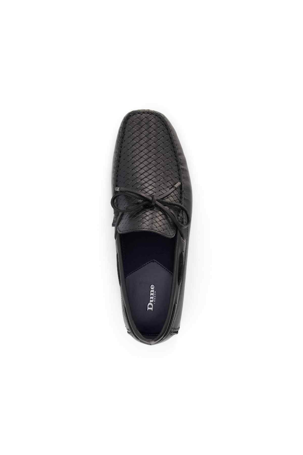 Black loafer top view with bow tie laces and woven texture