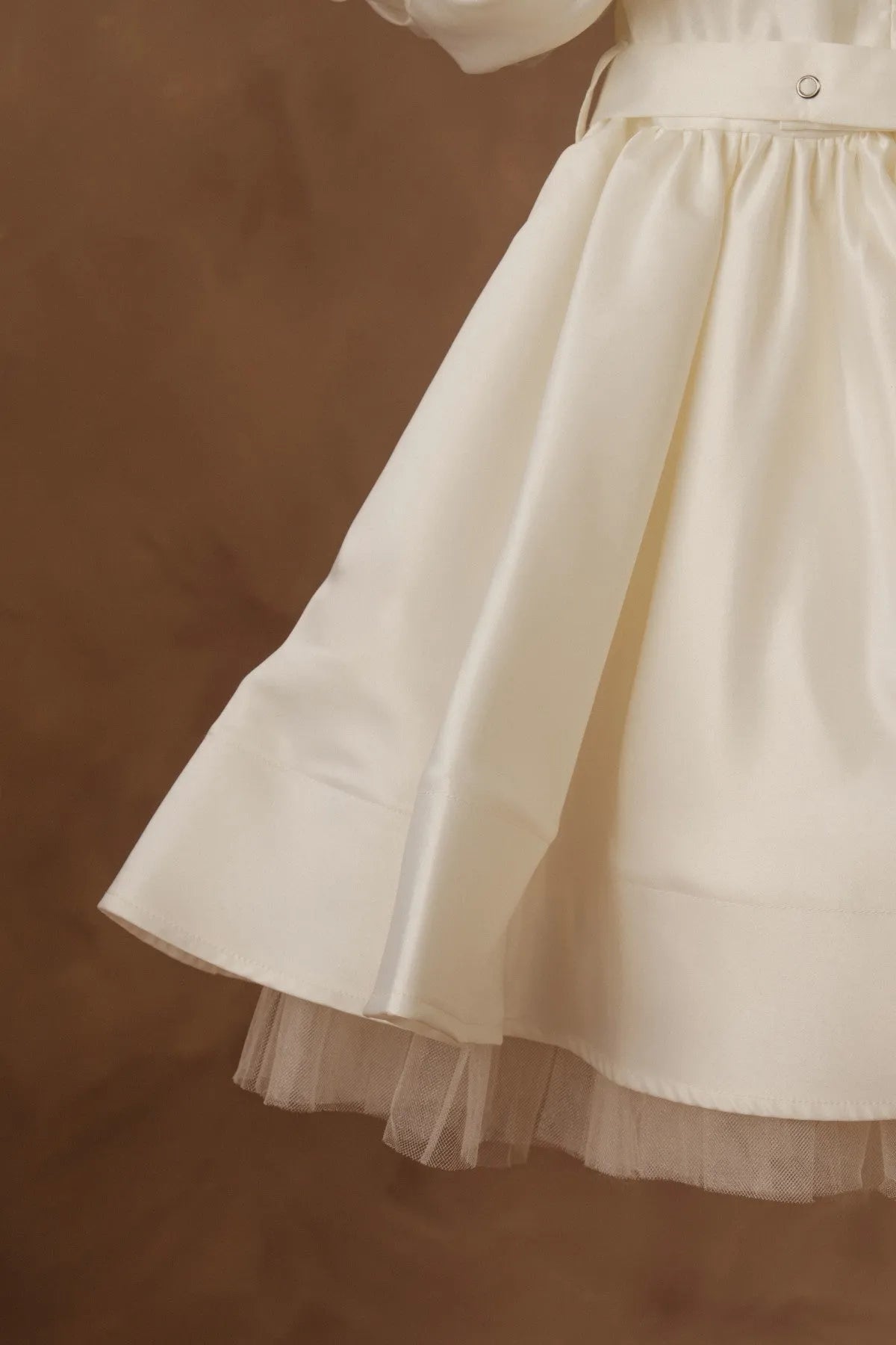 White dress close-up: flared skirt with layered tulle hem