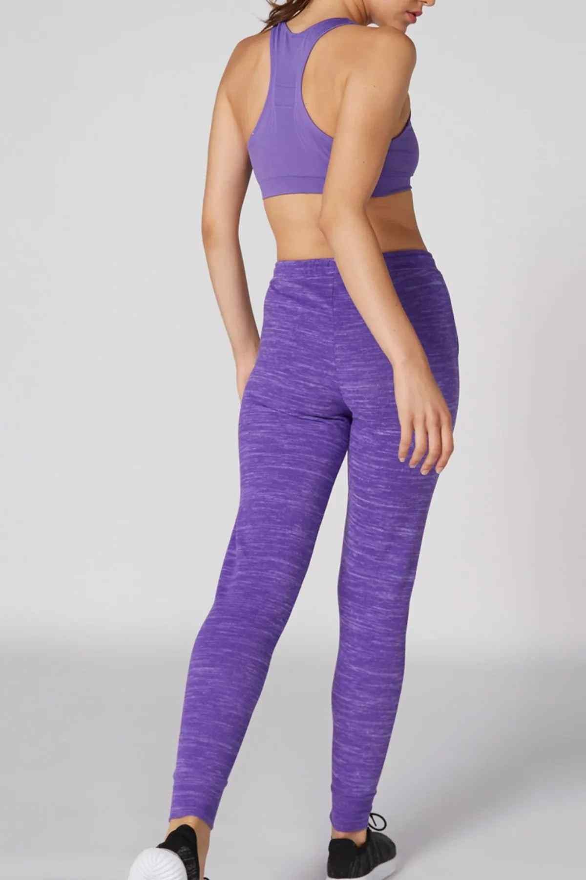 Purple sports bra and leggings set, back view with racerback top and textured tights