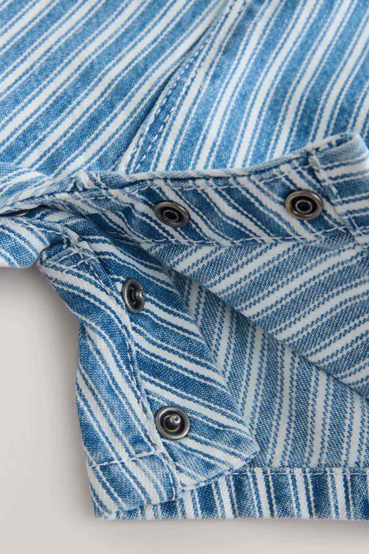 Blue-and-white striped romper close-up of button placket and gathered waist
