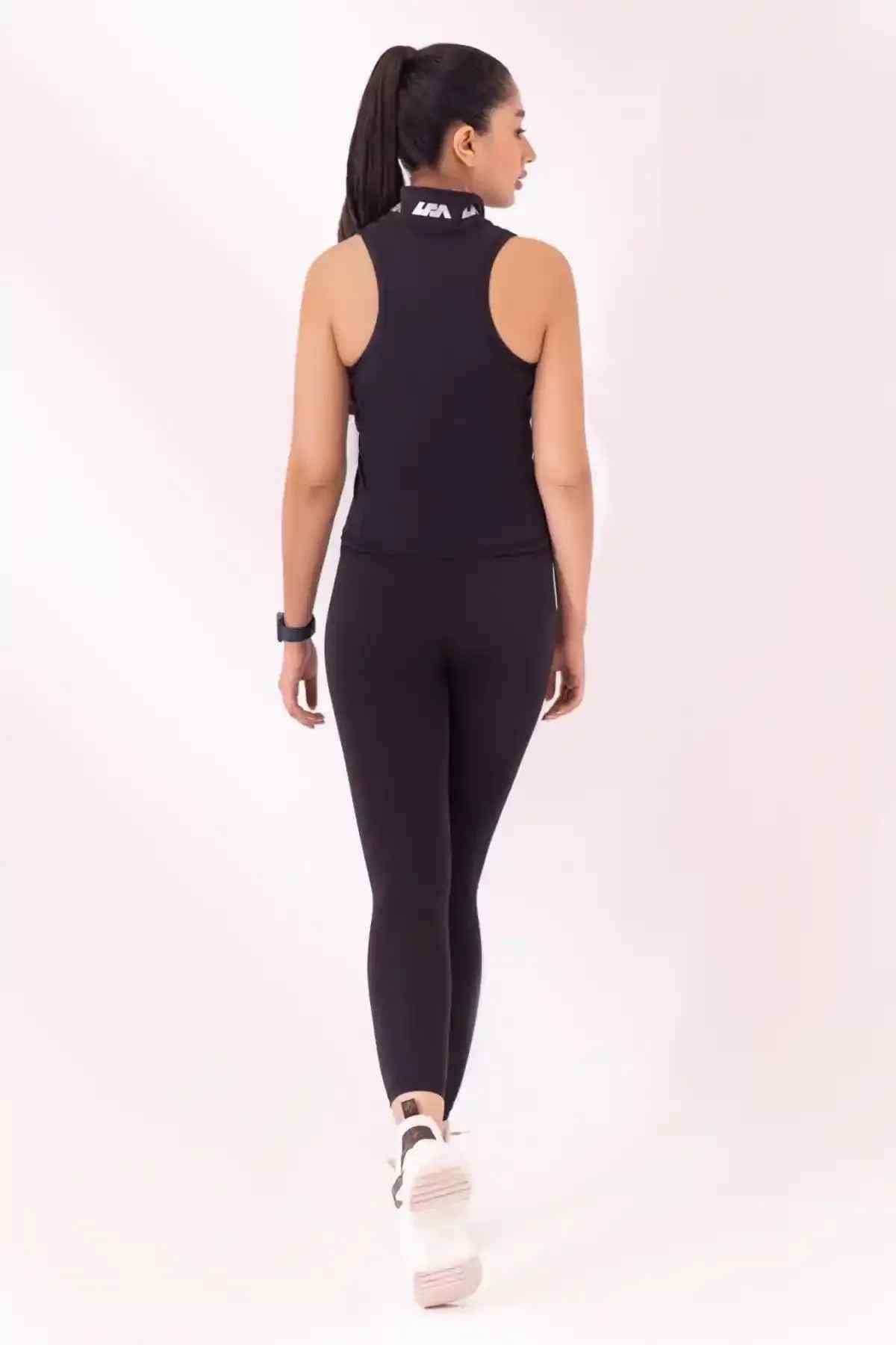 Black sleeveless athletic top and leggings set, back view