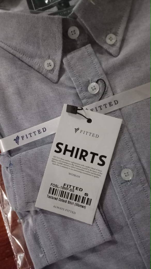 Gray fitted button-up shirt with pointed collar and button placket; clothing tag attached