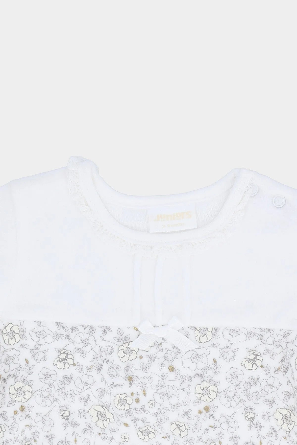White long-sleeve baby top with ribbed round neckline and small floral print yoke