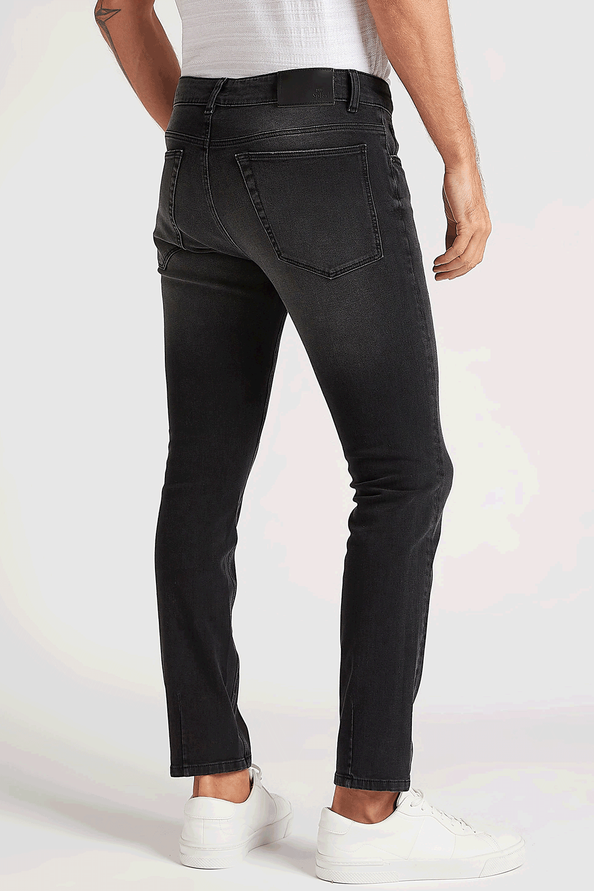 Black distressed jeans with back yoke and orange-brown rip accents