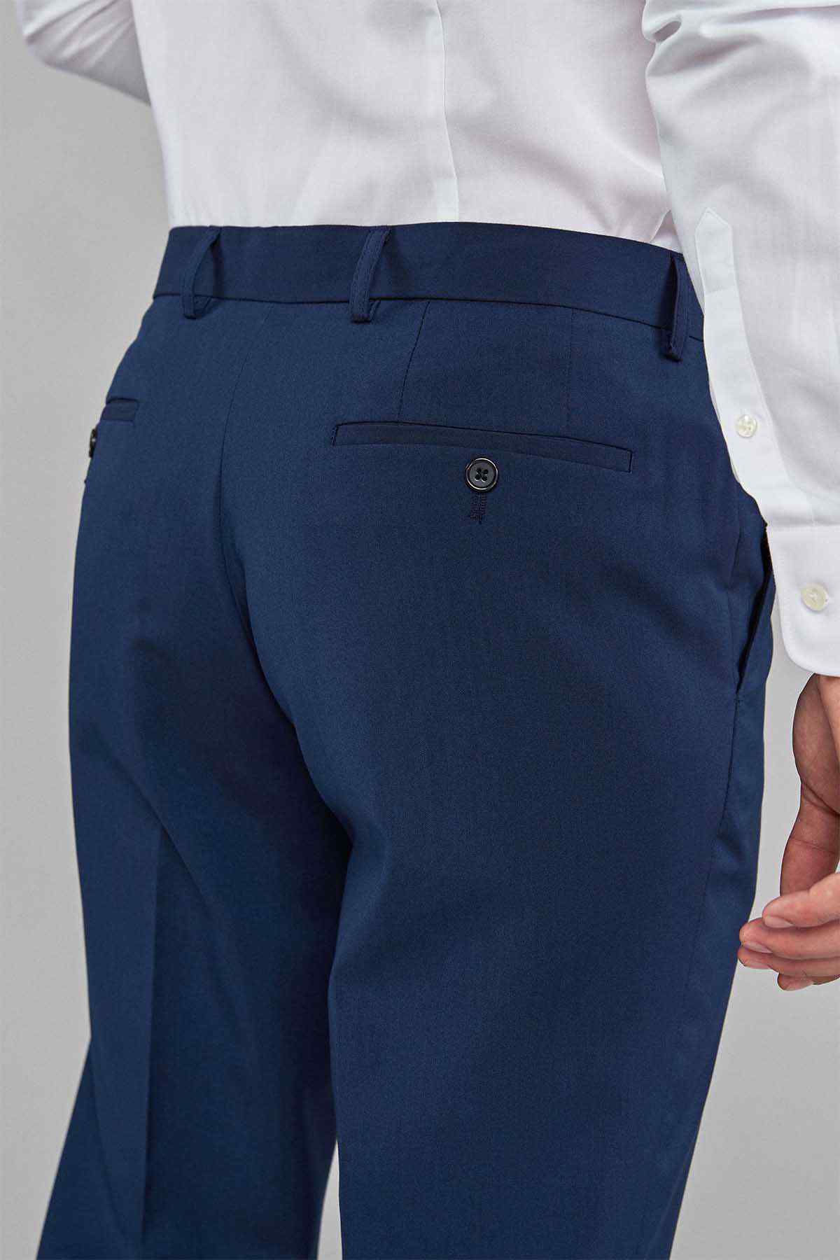 Men's navy blue dress trousers close-up of waistband button and front pocket