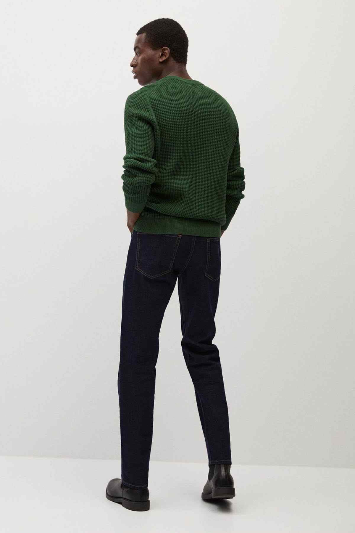 Green knit crewneck sweater back view with ribbed cuffs and hem