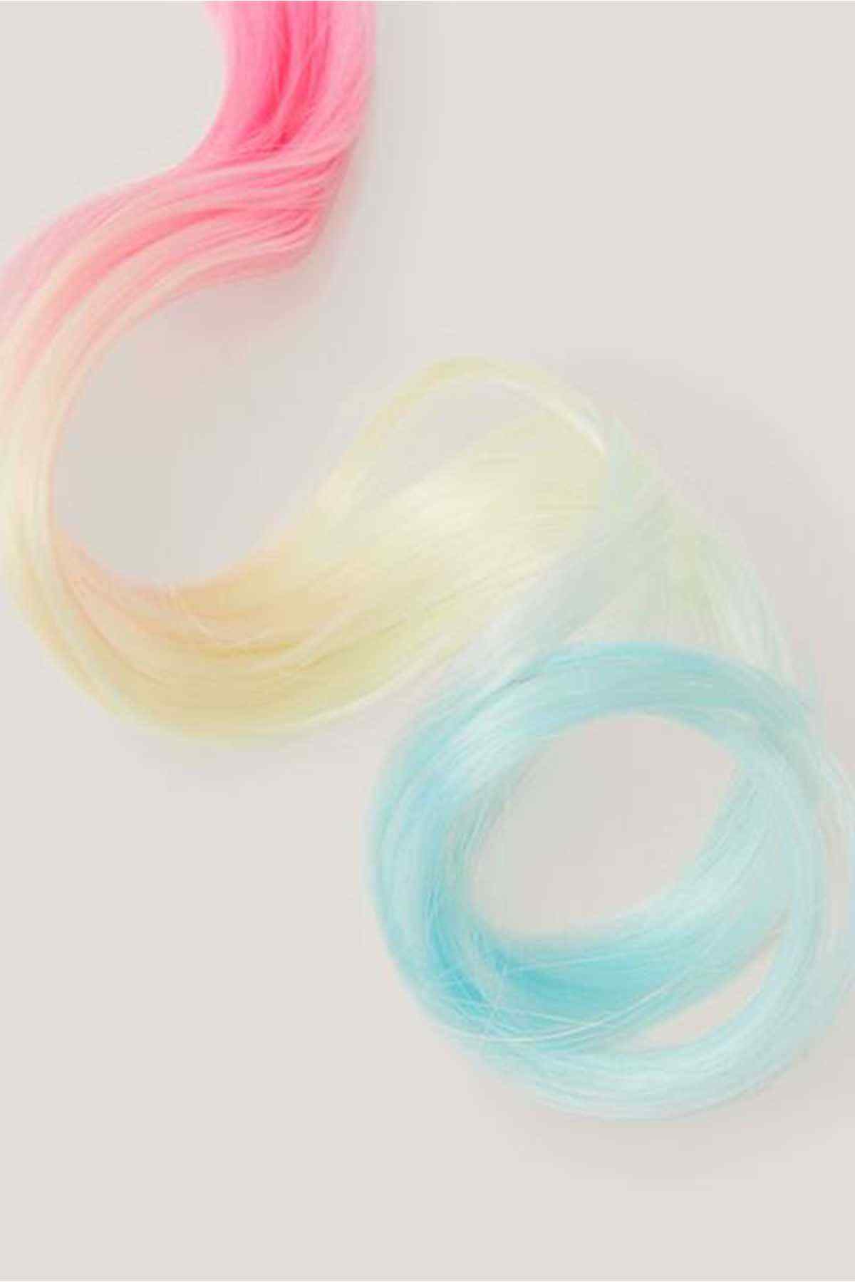 Pastel multi-color wavy hair extension strands in pink, yellow, and blue