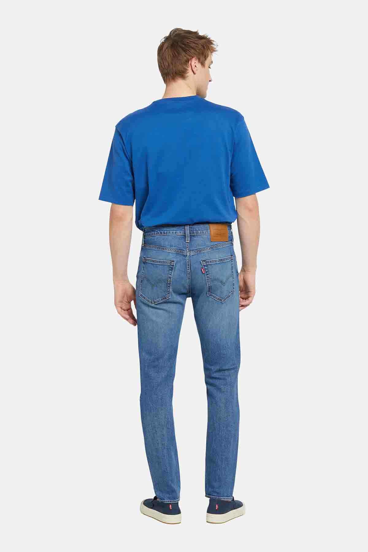 Blue crewneck T-shirt and blue jeans, back view, straight legs