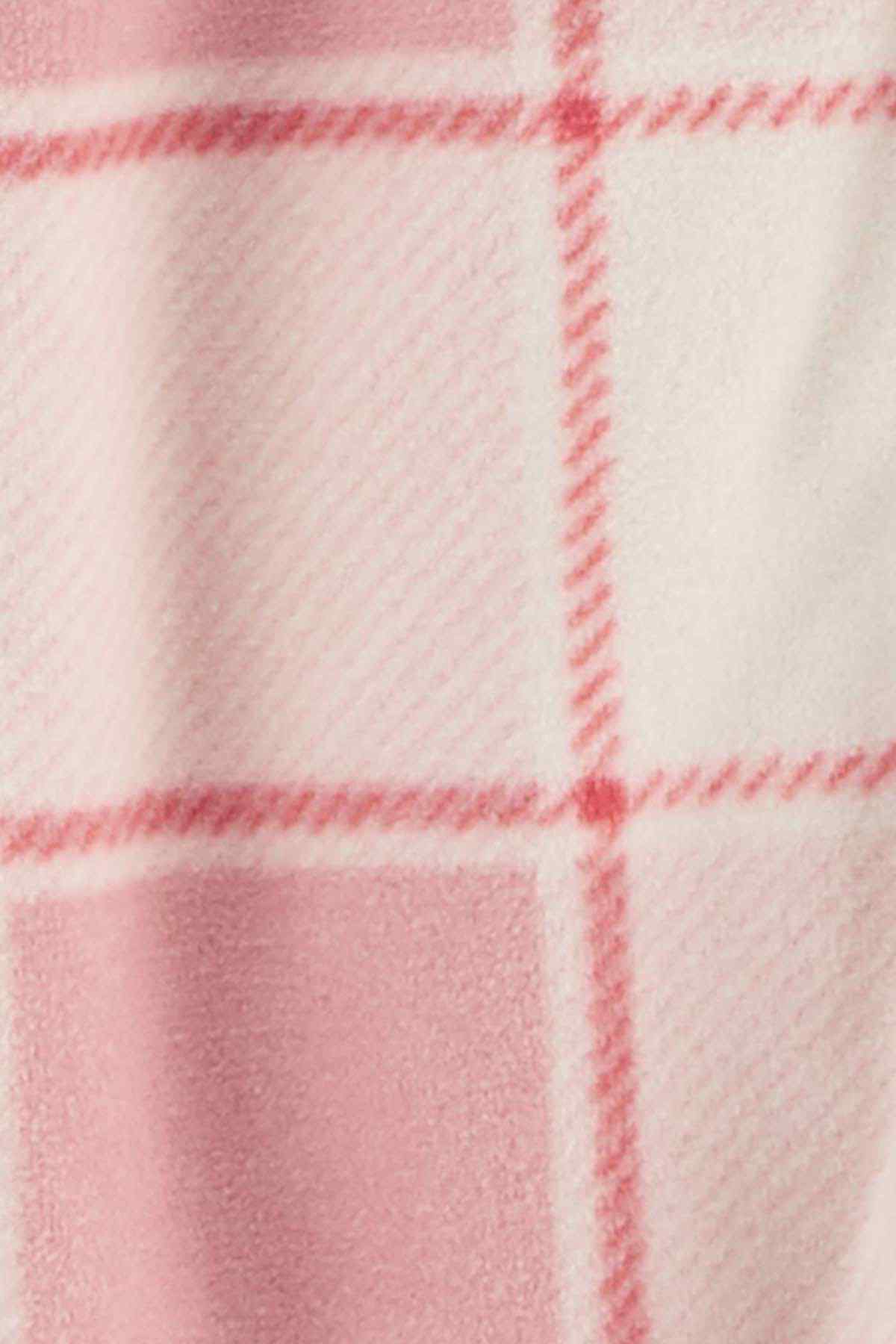 Pink and white plaid knit fabric close-up with red grid lines