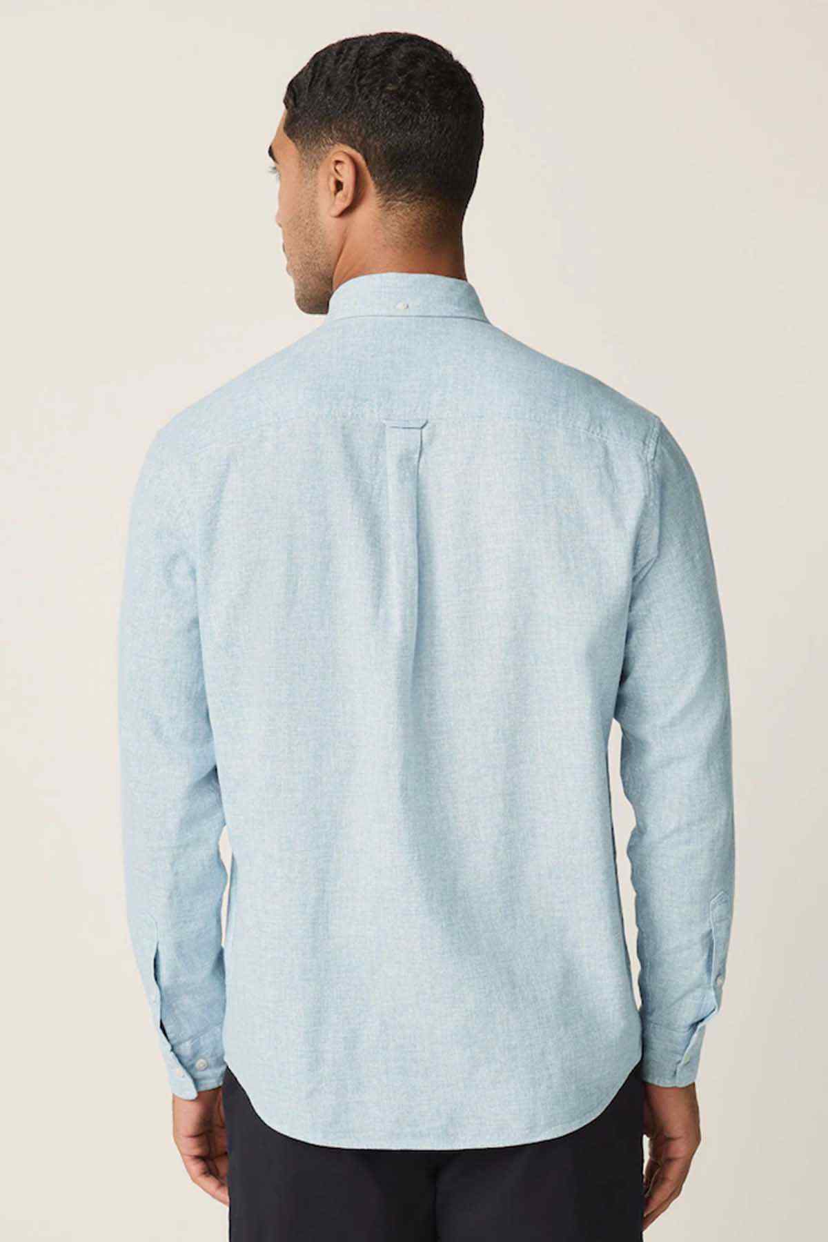 Light blue button-up shirt back view with yoke seam and long sleeves