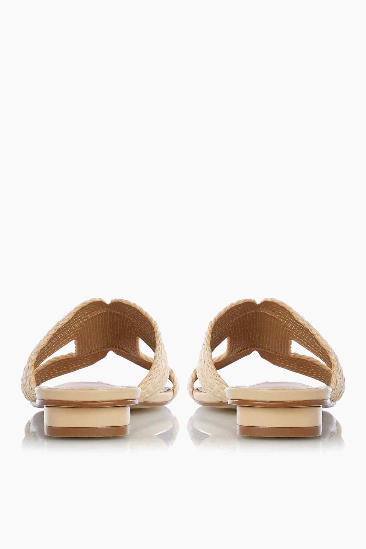 Pair of natural raffia slide sandals with open toe and low heel