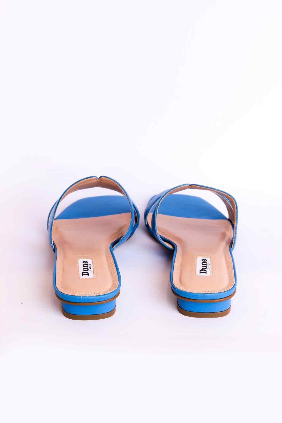 Blue back view slide sandals with open toe, tan heel trim and footbed