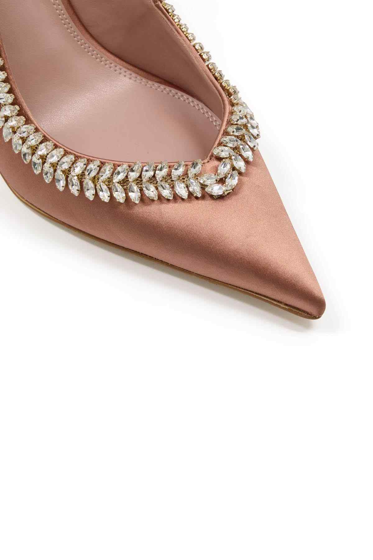 Blush pointed-toe pumps with rhinestone row across the upper edge