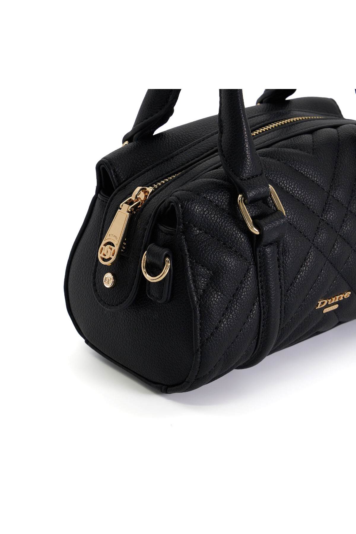 Black quilted handbag detail with gold zipper, handle rings, and front emblem