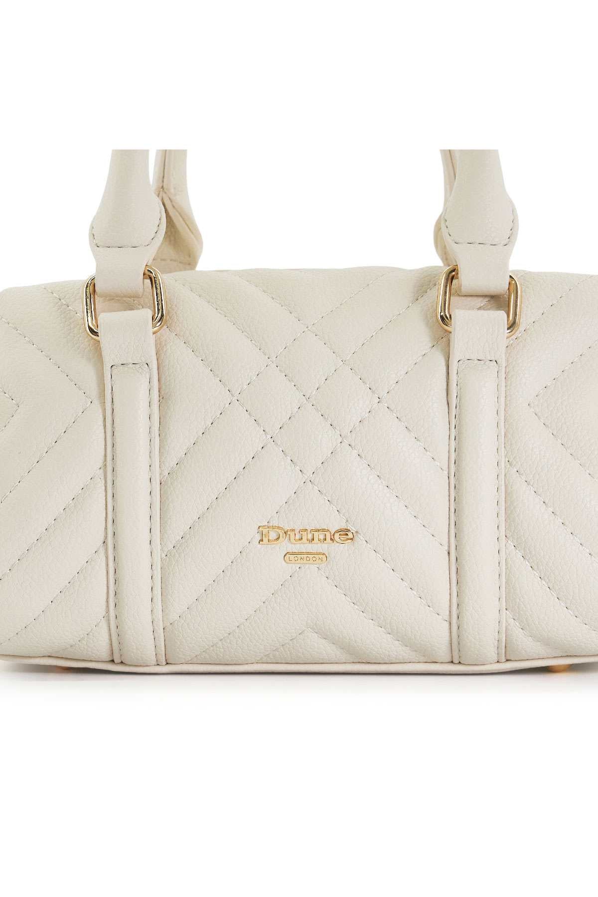 Ecru quilted front panel of Dune London handbag with gold logo and vertical straps