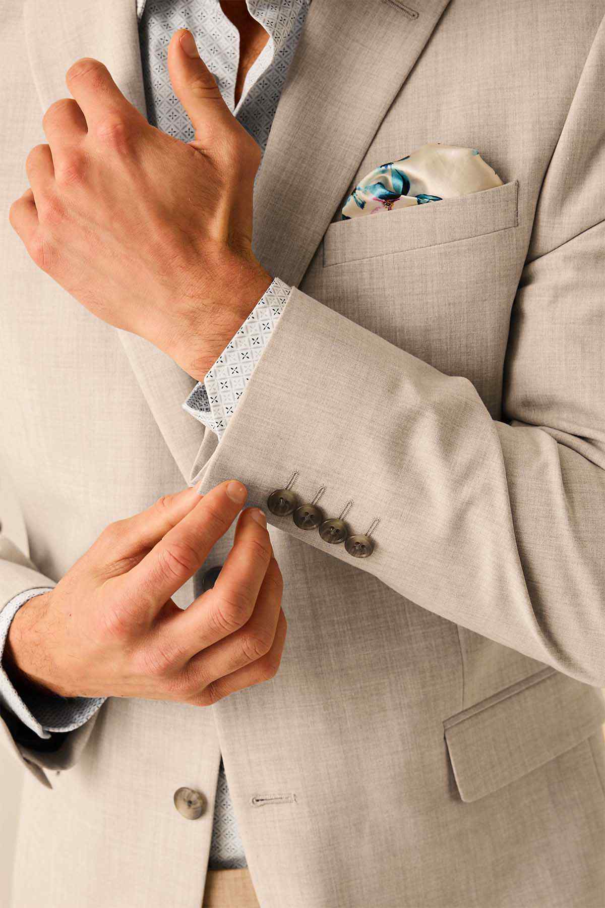 Stone suit jacket cuff and sleeve button detail, floral lining visible