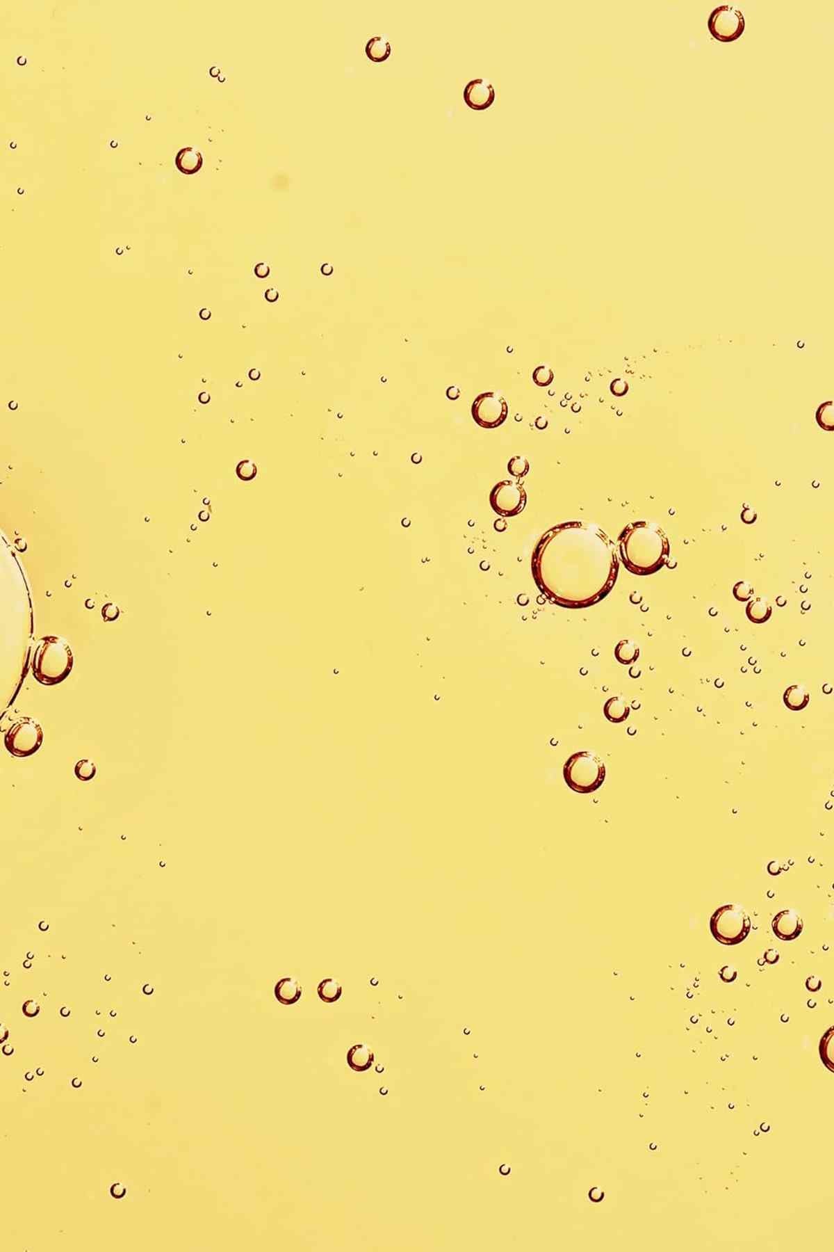 Noni glow face oil with golden-yellow liquid and small bubbles