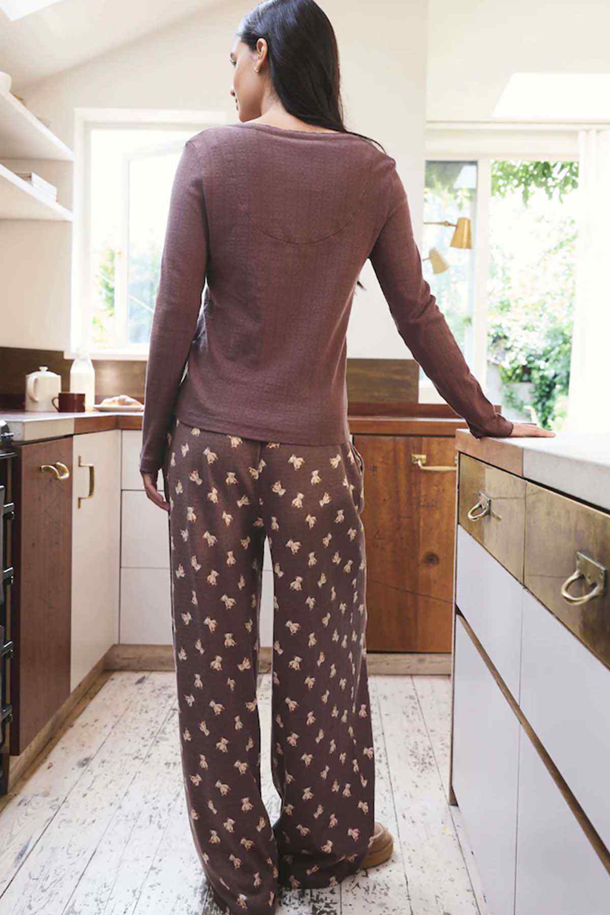 Chocolate brown long-sleeve henley top and printed wide-leg pajama pants, back view