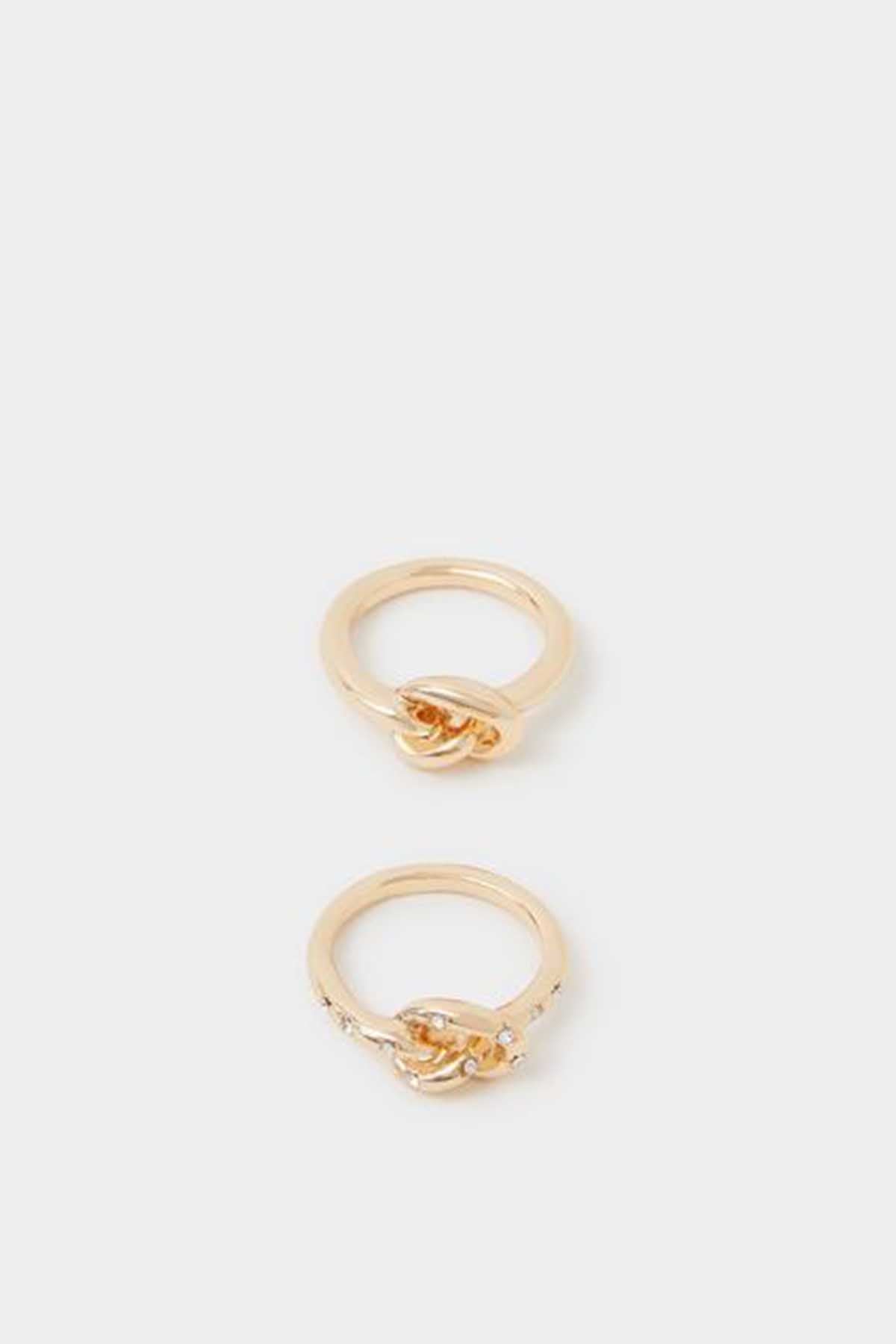 Two gold twisted rings with small clear stones on open bands