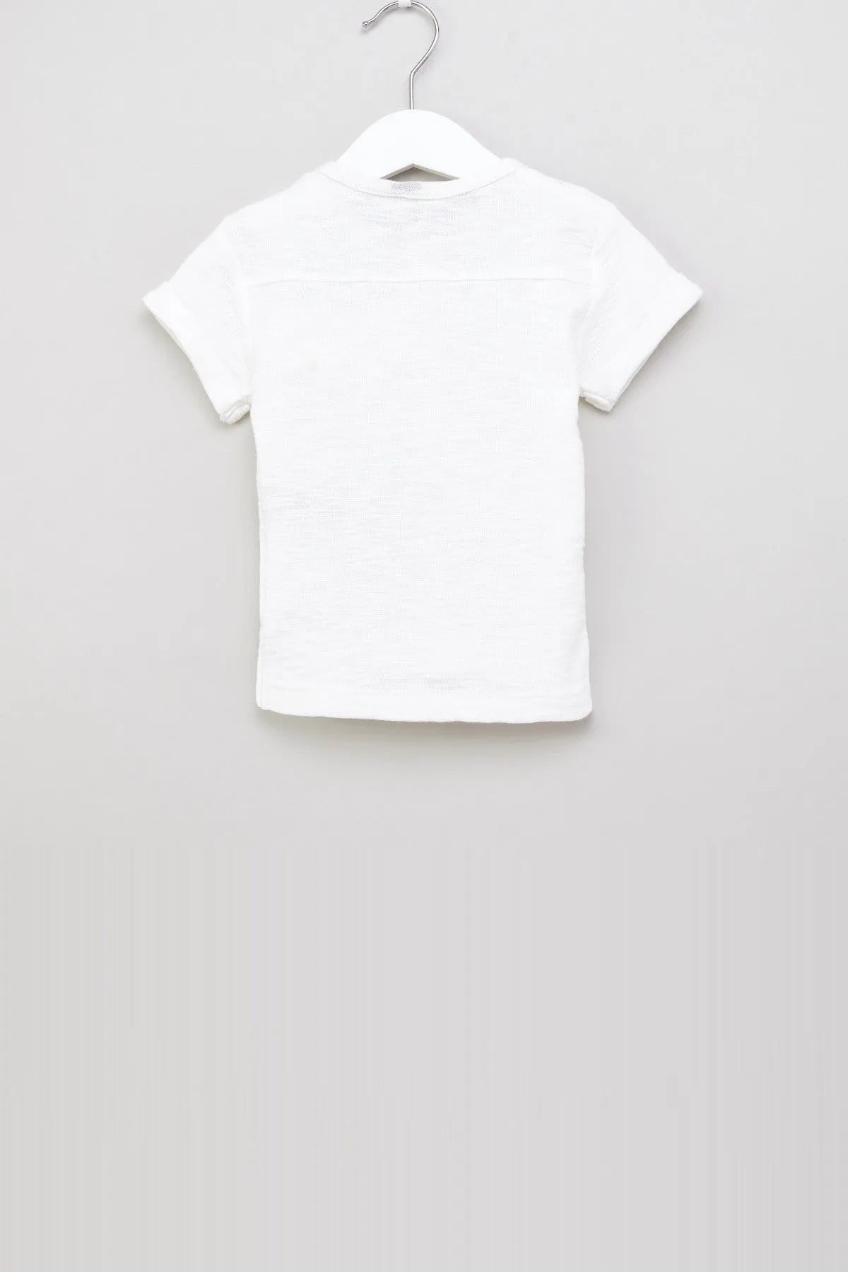White short-sleeve knit polo shirt with collar, on hanger