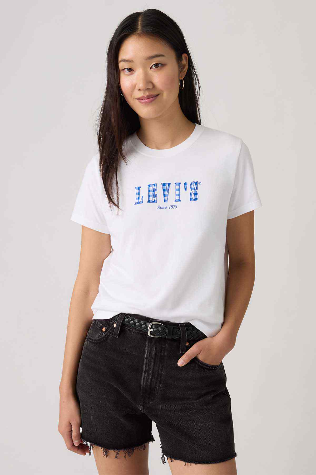 Levi's white crew-neck T-shirt with blue logo, worn with black denim shorts