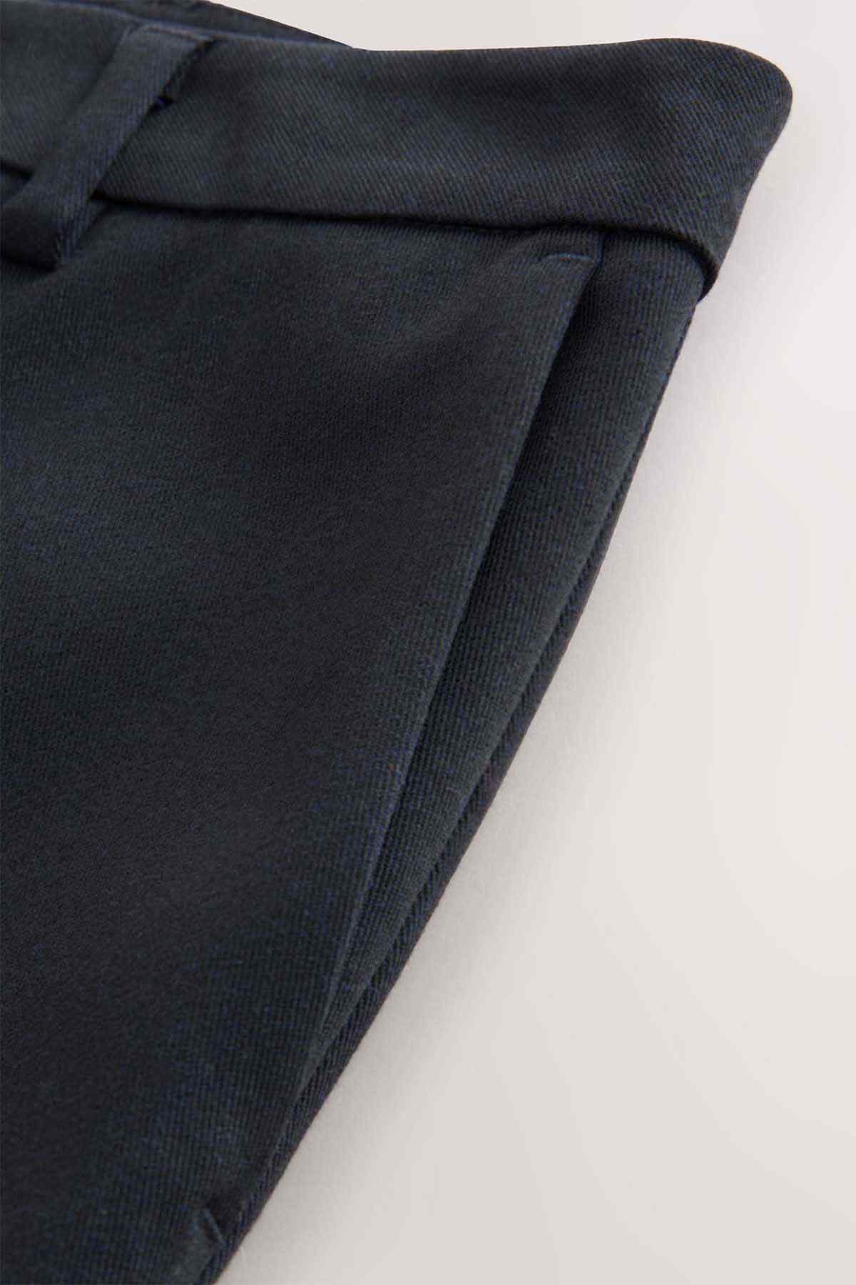 Navy woven trouser fabric with stitched hem and folded edge