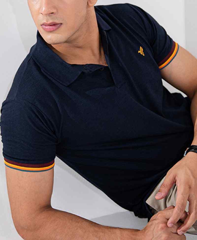 Close-up of navy fitted polo shirt with yellow-trim collar and sleeve edge