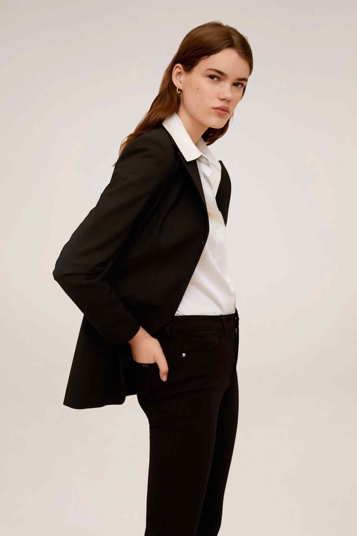 Black blazer and black trousers with white collared shirt