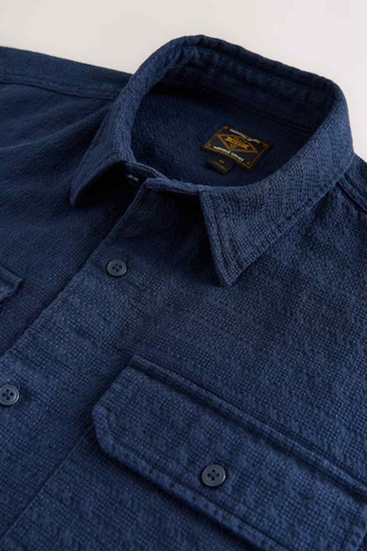Dark blue shirt close-up of neckline label and front button placket