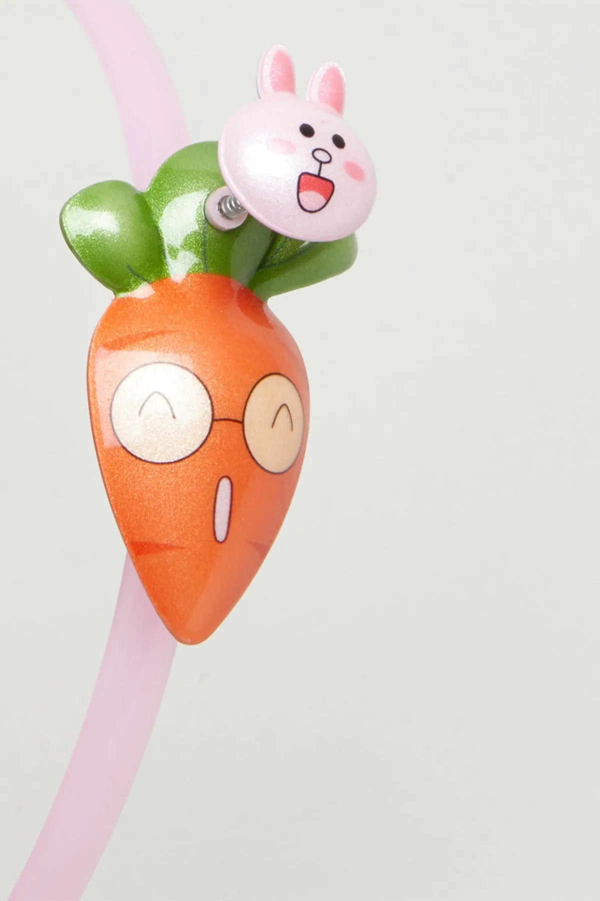 Multicolor baby headband detail: pink band with bunny and carrot plush faces
