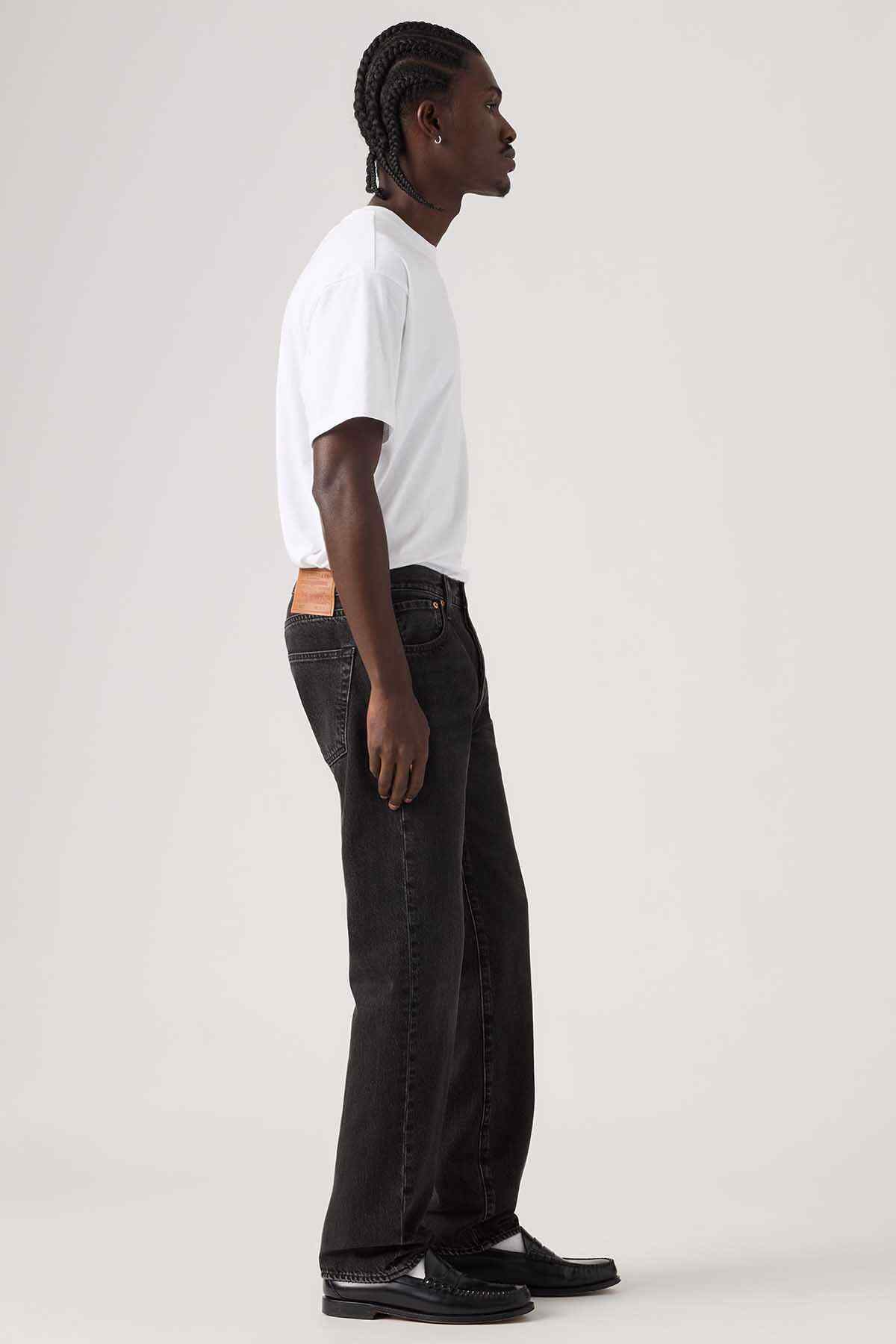 Levi's black denim jeans with straight leg and orange logo patch at waistband