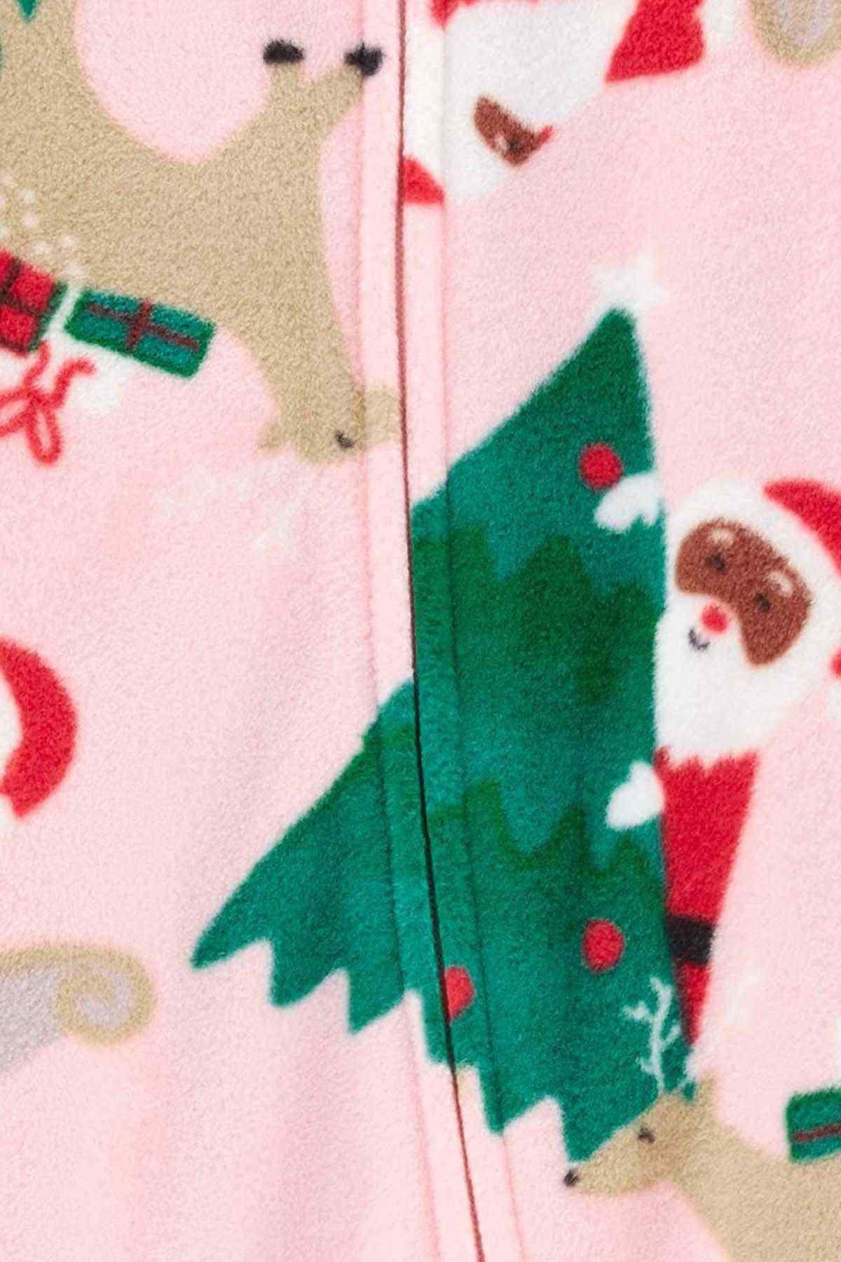 Pink fabric close-up with green tree and holiday animal print