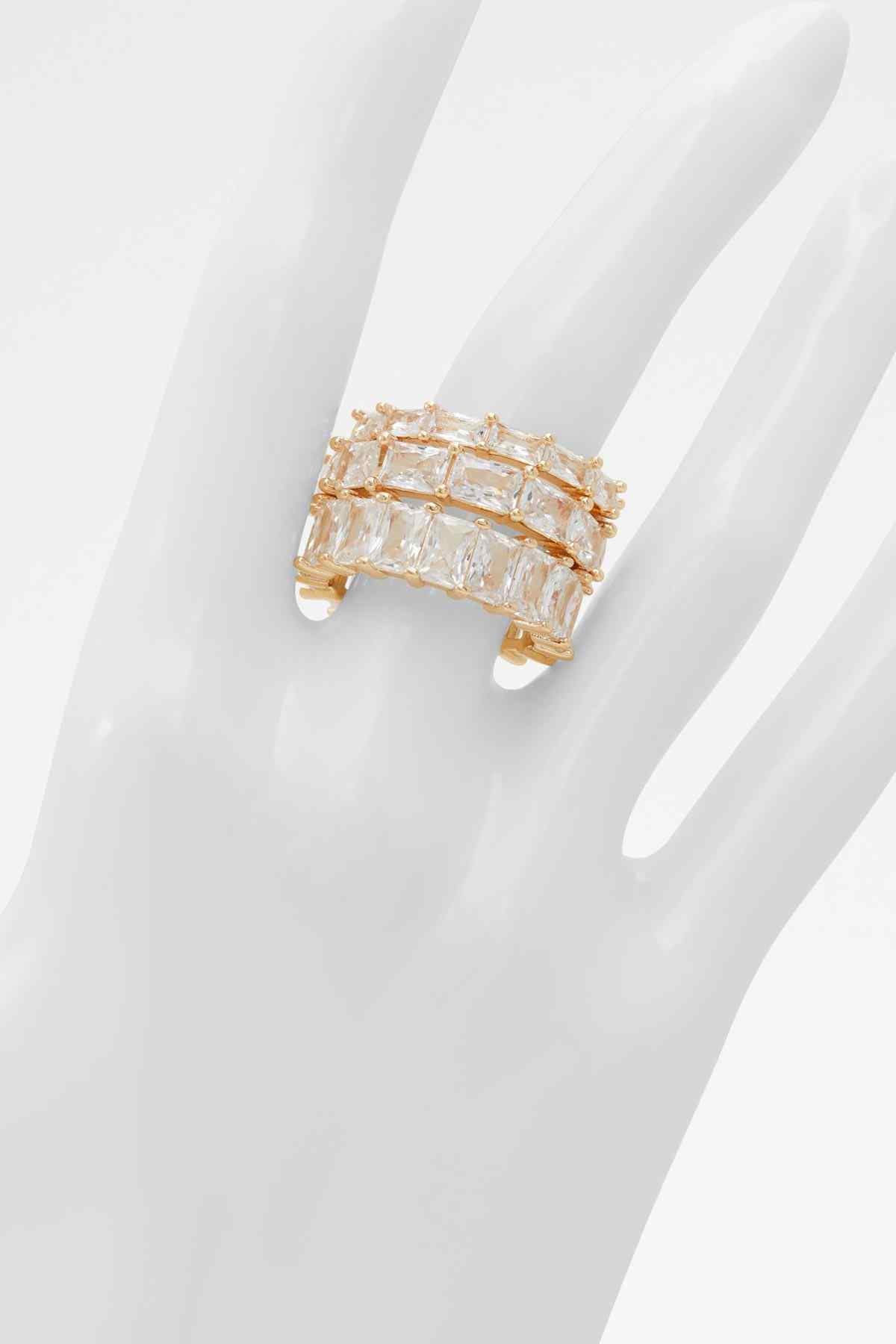 Gold-tone clear baguette crystal ring on finger, square-cut design