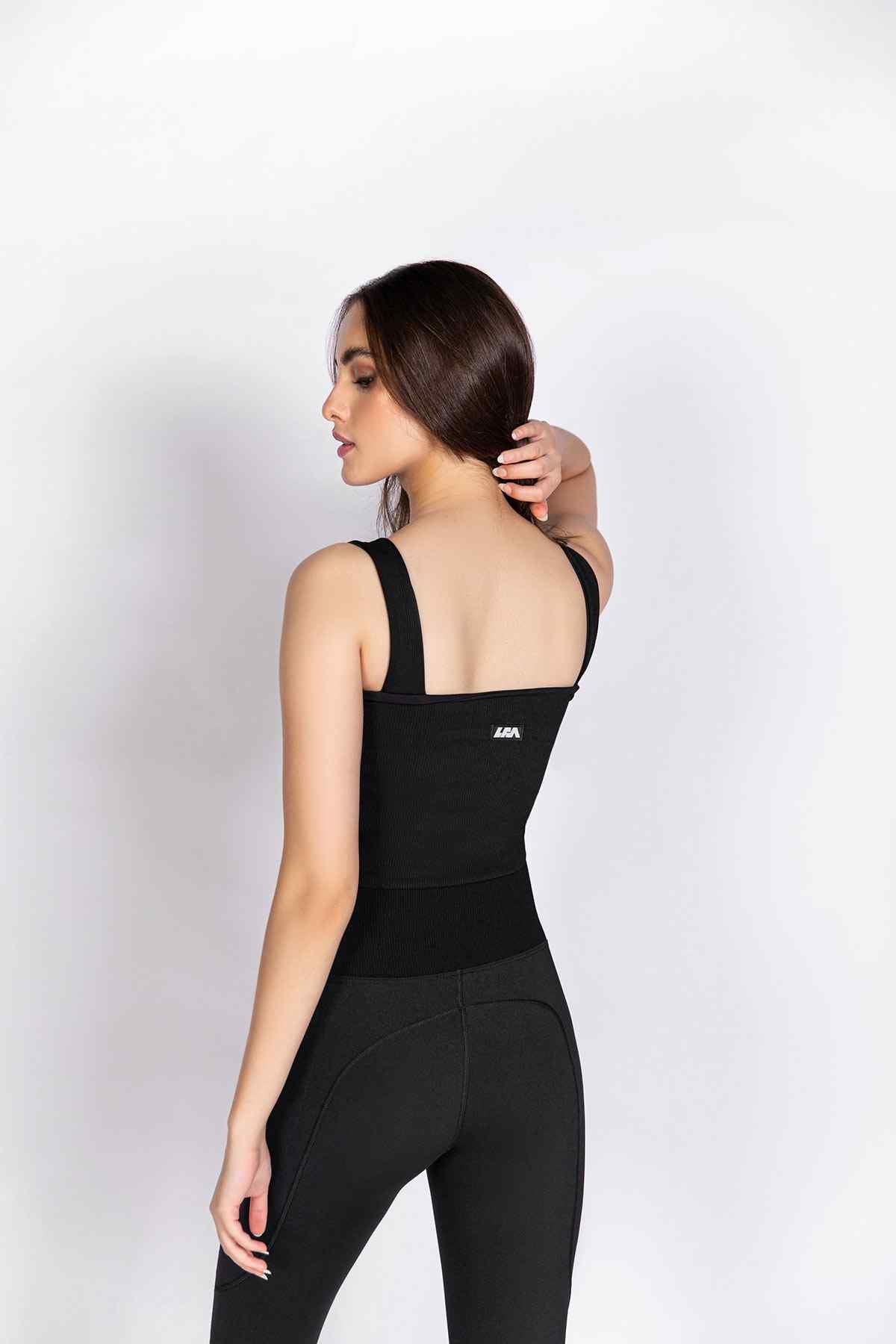 Black sleeveless athletic top and leggings, back view with racerback straps
