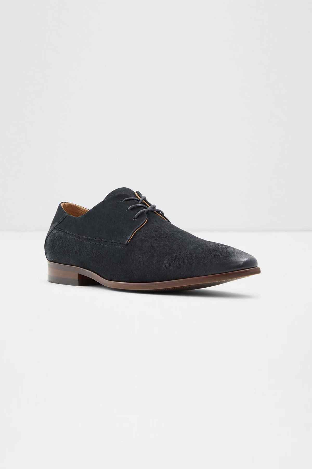 Black lace-up oxford shoes with tan laces and brown low heel, angled view