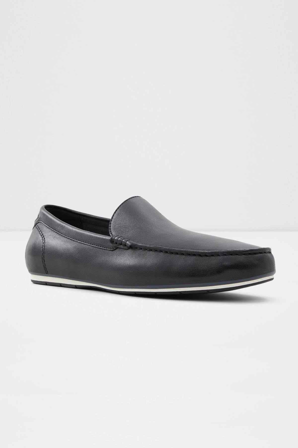 Dark leather slip-on loafer with low profile sole and moc-toe stitching